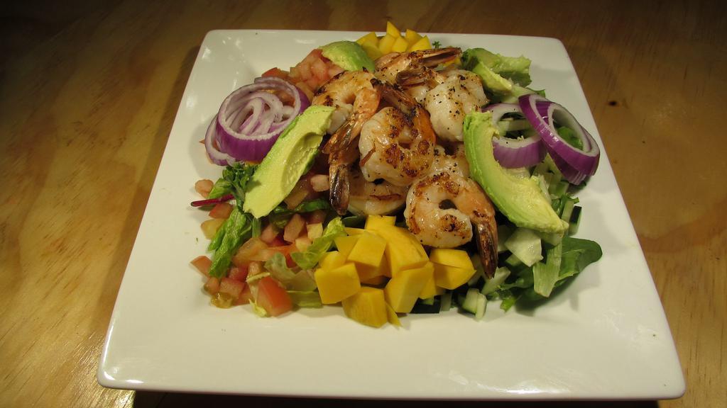 Ensalada De Camaron · Grilled blackened shrimps mixt lettuce, tomato, red onion, cucumber, avocado and mango mixt with chipotle dressing.