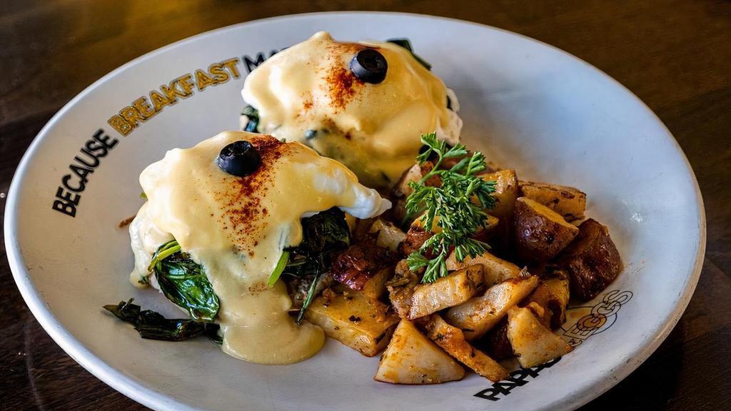 Eggs Benedict Florentine · Spinach and fresh tomato. English muffin topped with poached eggs, smothered with hollandaise sauce, served with roasted potatoes.