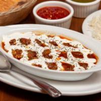 Badenjan Challow · Eggplant sautéed with fresh tomatoes, garlic and peppers topped with homemade yogurt. Served...