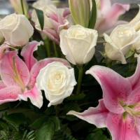 Roses and Lilies · This  arrangement comes in a vase and includes roses and lillies. *COLOR OF ROSES/LILLIES WI...