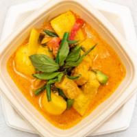 Butternut Squash Panang Curry · Panang paste, butternut squash, peanut sauce, coconut milk, peas, carrots, and kaffir leaves.