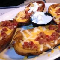 Potato Skins (4 Pcs) · Bacon, Jack, Cheddar cheese, and sour cream.