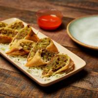 Burmese Samusas · Four handmade pastries filled with curried potatoes, mint and masala spices. Stuffed with gr...