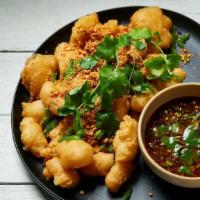 Salt & Pepper · Lightly battered, tossed with salt, and peppered, scallions, and jalapenos.