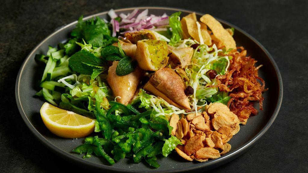 Samusa Salad · Vegetarian. Mixed table-side, this salad is made with vegetarian, hand wrapped, and home-made samusas tossed with falafels, cabbage, lettuce, cucumbers, mint, onions, and cilantro. A staff favorite.