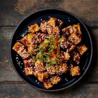 Sesame Tofu · Lightly battered and lightly fried organic tofu cooked with a sweet and tangy sauce. Topped ...