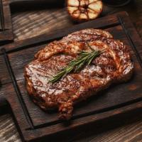 Ribeye Steak · A mouthwatering 12 oz Grilled Ribeye Steak seasoned to perfection. Served with a side of Ric...