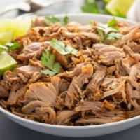 Carnitas · A delightful entrée of marinated Pork cut into cubes. Served with a side of refried beans an...