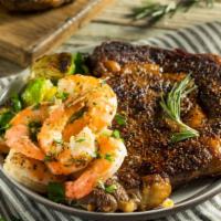 Ribeye Steak with Prawns · A mouthwatering 10 oz Grilled Ribeye Steak seasoned to perfection with 4 prawns. Served with...
