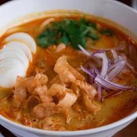 Coconut Chicken Noodle Soup · Rich in coconut milk soup served with chicken, egg noodles, had boiled-egg, cilantros, fresh...