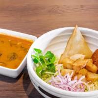 Samosas Soup · Tangy samosa soup with ginger, garlic, dry chili, mint, jalapenos, cabbage, onion, falafel a...
