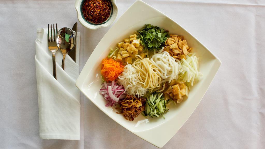Rainbow Salad · 4 types of noodles with potatoes, papaya, jalapenos, tomatoes, cabbage, rice, garlic chips, fried onions, fresh onions, tamarind juice and house chili sauce. (Gluten Free option, Vegan Option, Dairy Free)