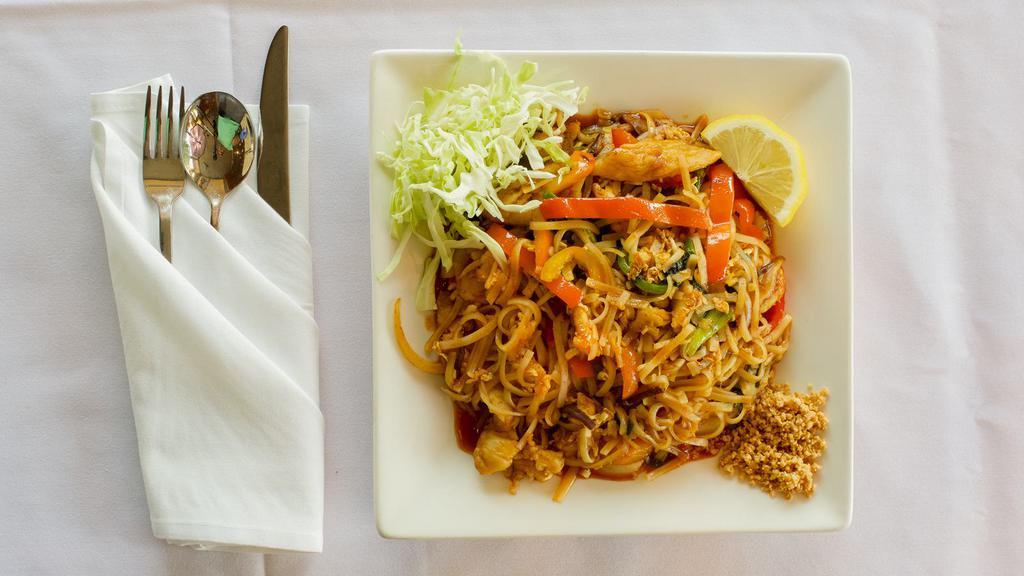 Spicy Noodle · Stir-fried rice noodle with red bell peppers, mushroom, bean sprouts, onions, pea shoots, scallions, scrambled egg, garnished with crushed peanuts, cabbages, and lemon wedges. (Gluten Free)