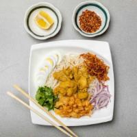Golden Noodle Salad* · Rice noodles served with coconut curry chicken, fresh onions, fried onion, boiled egg and ci...