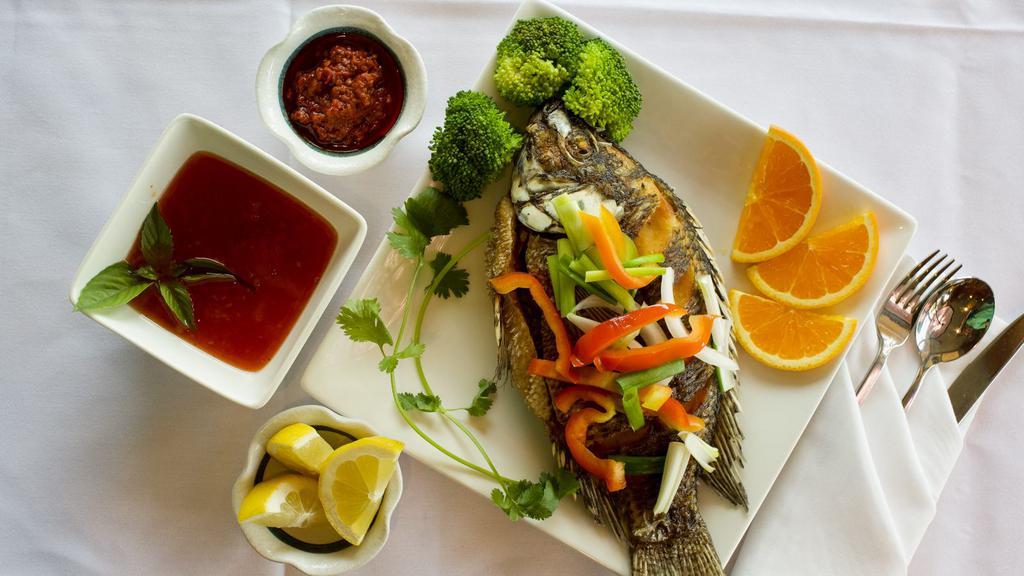 Whole Tilapia fish · Fried whole Tilapia fish with Choice of sauce, come with onions, and bell peppers
