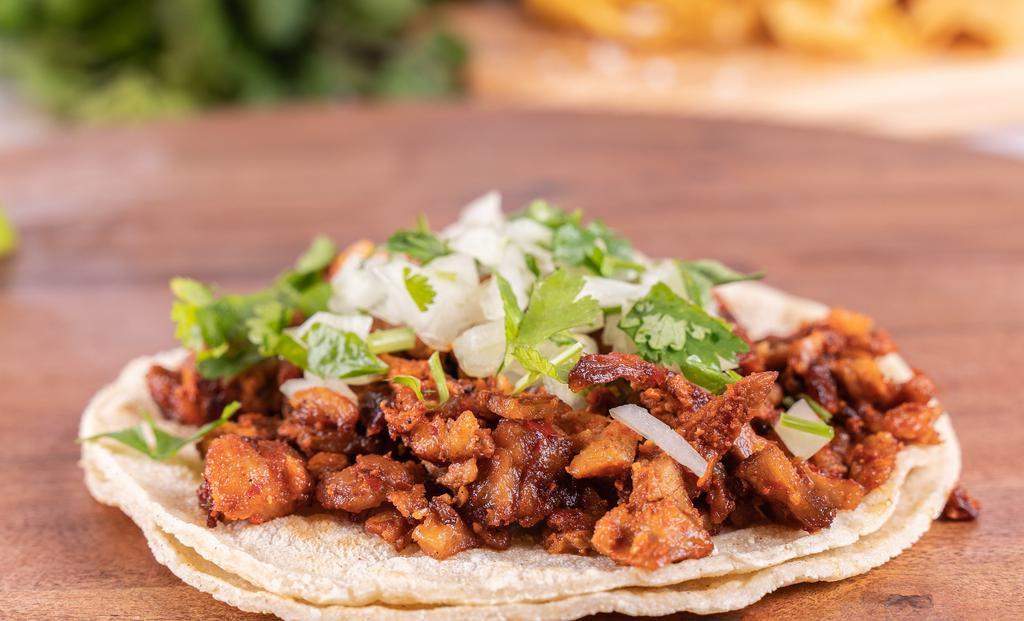 Regular Taco · Choice of meat, onion and cilantro served on a soft home made corn tortilla.