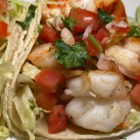 Regular Shrimp Taco · Grilled shrimp served on a corn tortilla with tomato, onions, cilantro and lettuce.