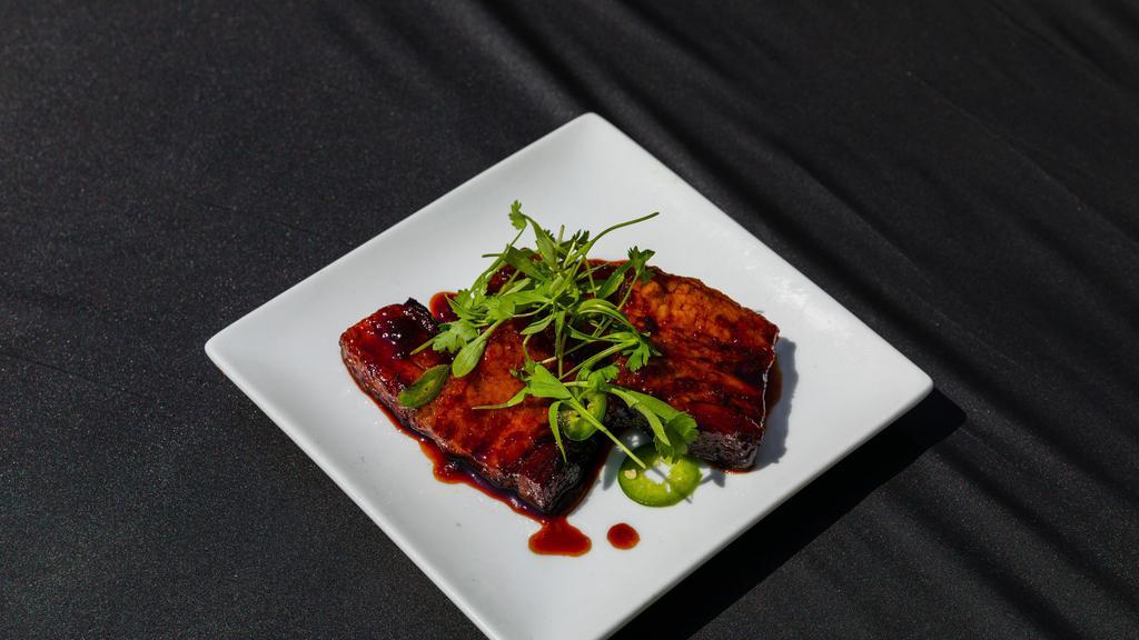 BBQ Pork Belly · Tender and juicy BBQ Pork Belly lacquered in a sweet and spicy soy glaze topped with jalapeños and cilantro. It's sticky and bursting with flavor, and it pairs perfectly with our noodles.
