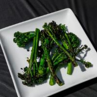 Grilled Broccilini · Tender, juicy, and crunchy charcoal grilled broccolini. It adds great texture if you order i...