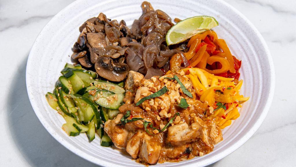 Thrive Peanut Chicken Bowl · Marinated chicken with caramelized onions, roasted mushrooms, papaya slaw, cucumber slaw, basil, sesame seeds, and our peanut sauce. Served with a lime wedge and a base of your choice. (Gluten-Free)