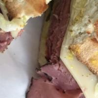 New Yorker Sandwich · Pastrami, swiss, coleslaw, mustard and pickles on light rye.