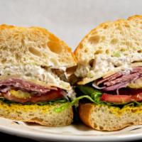 Sunset Special Sandwich · Pastrami, swiss and chicken salad. Served with mayo, mustard, lettuce, onions, tomatoes, pic...