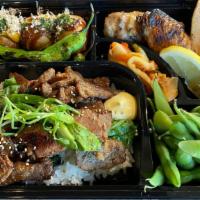 Yakiniku Teba Shio Bento · Barbecued beef over rice, Grilled chicken wings, takoyaki, kimchi and edamame