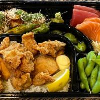 Karaage Bento · Fried boneless chicken over rice, sashimi, takoyaki, and edamame
