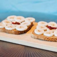 Reishi Peanut Butter Toast · Gluten-free toast, reishi peanut butter, banana, goji berries