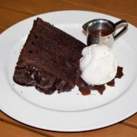 Six Layer Chocolate Cake · Served with caramel chocolate sauce & vanilla bean ice cream