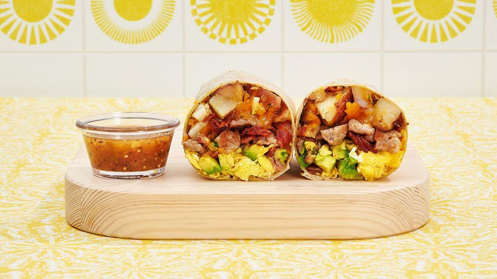 Everything but the Kitchen Sink Breakfast Burrito · Two scrambled eggs, bacon, carne asada, roast pork, breakfast potatoes, avocado and melted cheese wrapped in a flour tortilla.