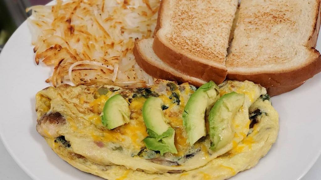 Veggie Omelette · tomatoes, bell peppers, onions, cheddar cheese, avocado & mushroom omelette  with hash browns and toast