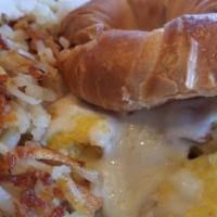 Croissant Sandwich · Scrambled Eggs, Ham, Mozzarella cheese. Served with Hash Browns