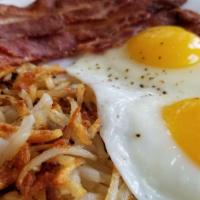 Eggs YOUR WAY · 2 freshly cracked eggs cooked YOUR WAY and 1 breakfast meat of your choice, served with Hash...