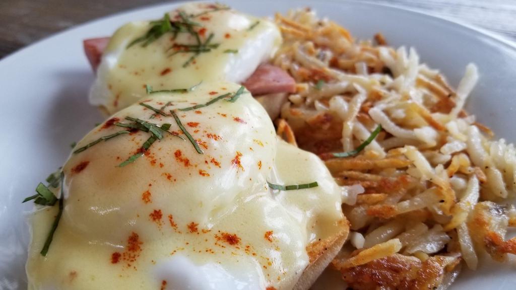 Classic Eggs Benedict  · Two poached eggs served on top of a english muffin and Canadian Bacon. Topped with Holandaise sauce.