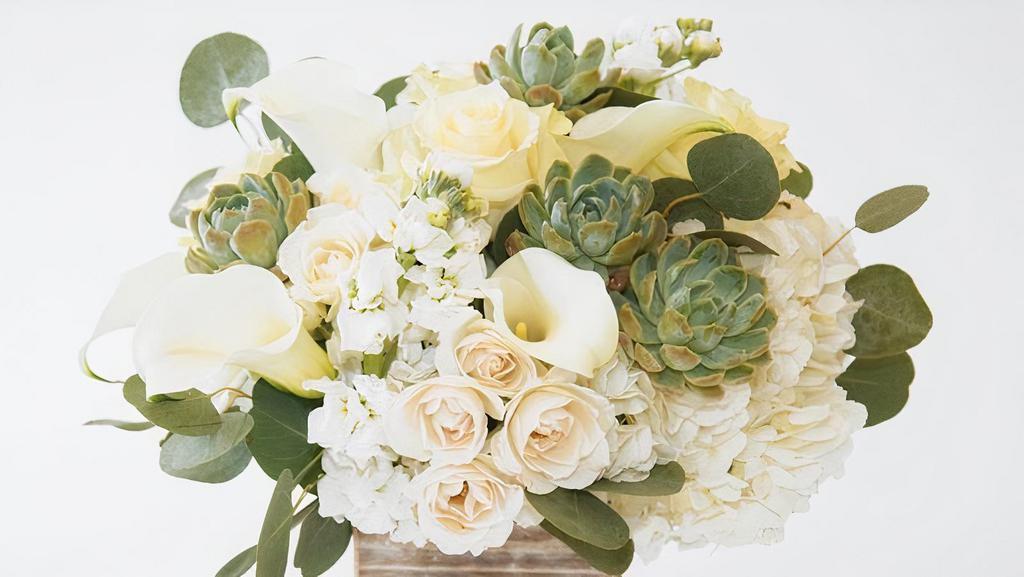 Laguna Beach · White Hydrangea, Roses and more are arranged in a wooden cube.