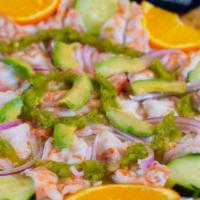 Aguachile · Shrimp cooked with lime juice, onions, cucumber. served with hot sauce