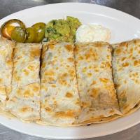 Quesadilla Deluxe · Our tortilla layered with cheese, mushrooms and onions. Grilled and topped with sour cream, ...