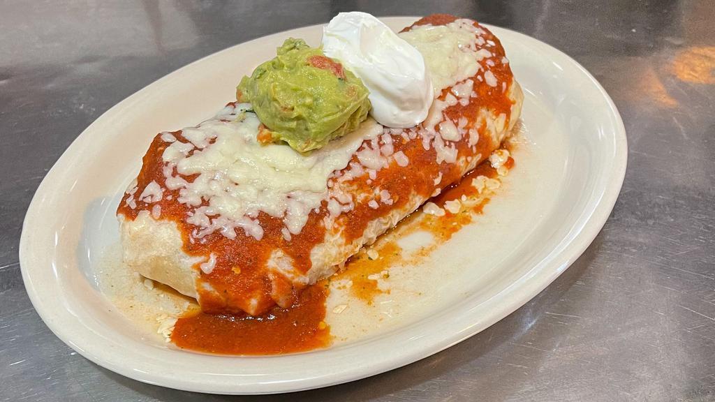 Super Burrito · A large flour tortilla filled with your choice of meat, beans and rice. Topped with sauce, cheese, guacamole and sour cream.