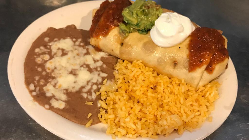 Chimichanga · Flour tortilla filled with beans, cheese and your choice of meat. Rolled and deep fried. Topped with sauce, sour cream and guacamole. Served with beans and rice.