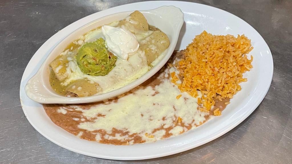 Enchiladas in Salsa Verde · Gluten-Free. Two corn tortillas, filled with your choice of meat, covered with tomatillo sauce and cheese. Topped with sour cream and guacamole. Served with beans and rice.