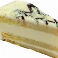 Tres Leches Cheesecake · Cake soaked in the traditional three milks, layered with rich creamy cheesecake and drizzled...