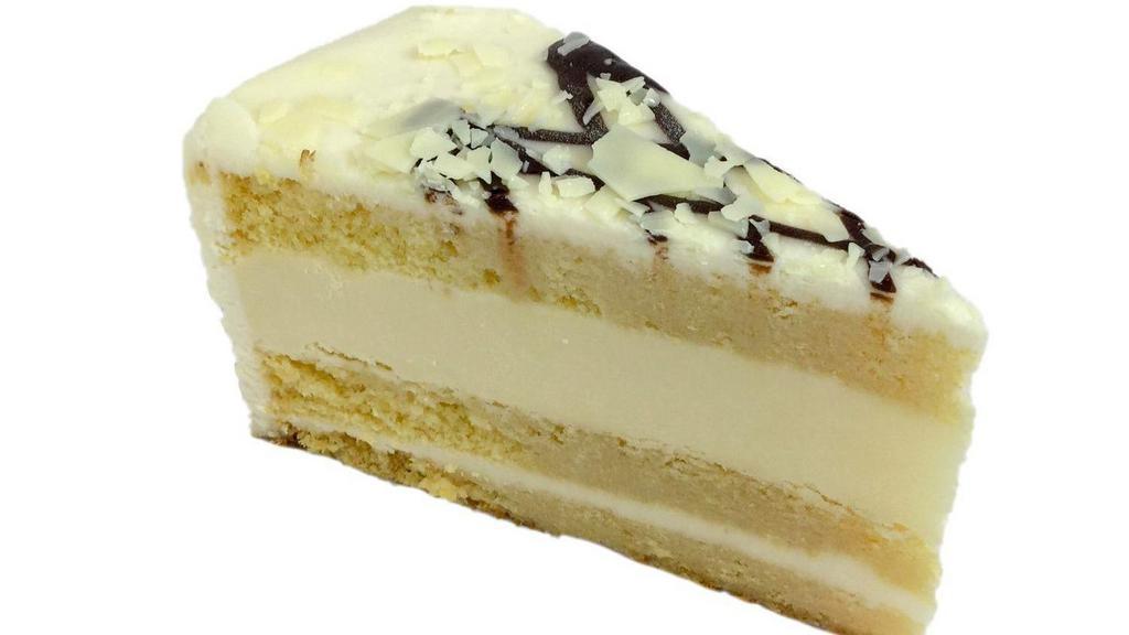 Tres Leches Cheesecake · Cake soaked in the traditional three milks, layered with rich creamy cheesecake and drizzled with chocolate to create the perfect sweetness.