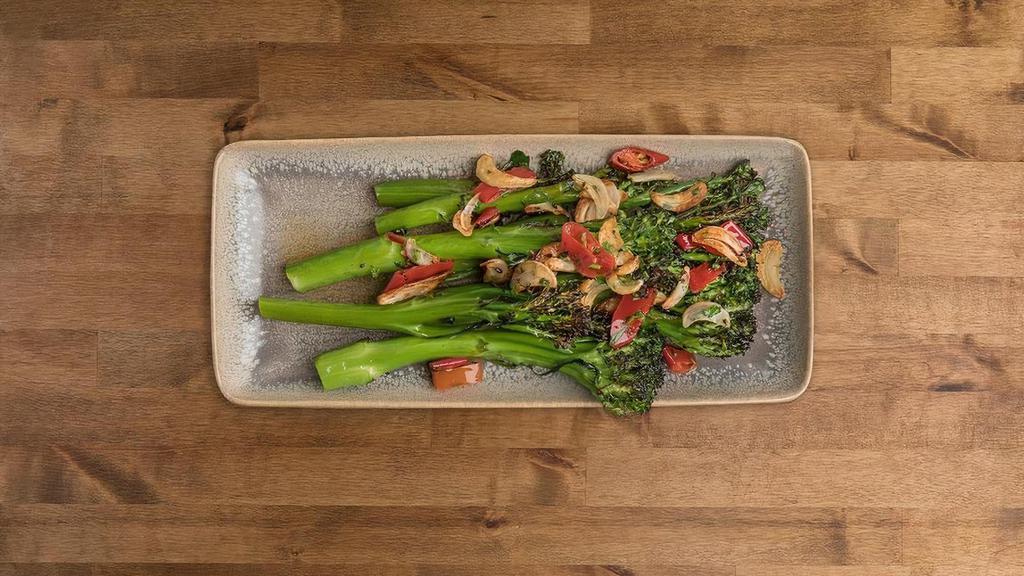 BROCCOLINI · Blanched broccolini, sautéed and roasted in the oven with EVOO and sliced garlic, topped with calabrese peppers.. Allergies: Garlic