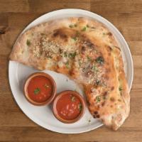 CALZONE · Folded pizza dough. Pizza Tomato Sauce, scarmoza, Italian sausage, kale, caramelized onion, ...