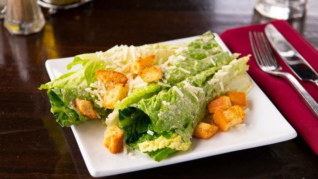 Classic Caesar Salad · Heart of romaine lettuce with house-made croutons, fresh garlic, parmesan cheese, and our own Caesar dressing. Choice of size.