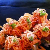 53. Volcano · Spicy. Shrimp tempura, crab topped with tuna, salmon, and spicy kani & green tobiko.
