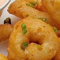 Onion Rings · Onion Rings coated in our  Cod Damn Shatter Batter fried and tossed with green onion  and To...