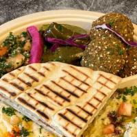Falafel Plate · Turmeric Rice Topped With Fresh Falafels, Tomatoes, Onions and Tahini Sauce Served With a Si...