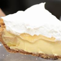 Key Lime Pie · A slice of Key lime filled, whipped cream topping, and graham cracker crust.